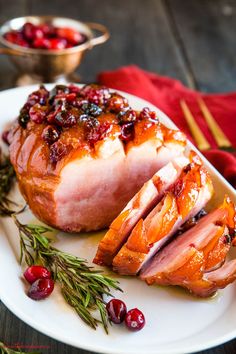 sliced ham with cranberry sauce on a white plate