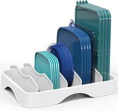 the dish rack is filled with plates and dishes in blue, green, and white