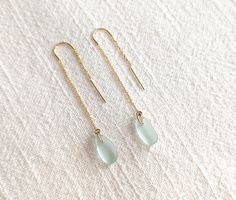 Sterling Silver Option: https://www.etsy.com/listing/1593267708/genuine-sea-glass-threader-earrings?click_key=3a11e3ffea65cafe1aae3a432c475c03dd824adb%3A1593267708&click_sum=0ddc3edf&ref=shop_home_recs_11&pro=1&frs=1 These delicate and eye-catching sea glass threader earrings are perfect for the minimalist and beachy jewelry lover. The sea glass's brillance is captured from every angle and glistens while you move. The "U" threader allows the earring to sit comfortably in your earlobe and prevent Sea Glass Gifts, Ultrasonic Jewelry Cleaner, Beachy Jewelry, Sea Glass Colors, Les Angles, Sea Glass Earrings, Sea Glass Pendant, Sea Glass Necklace, Threader Earrings