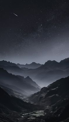 the night sky is lit up over mountains and valleys with stars in the sky above