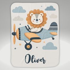 a baby blanket with a lion on it and an airplane in the sky behind it