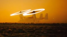 an airplane is flying through the air with two circles in front of it and dust behind it