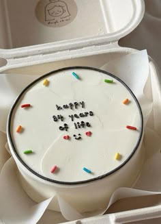 a birthday cake in a box with writing on it