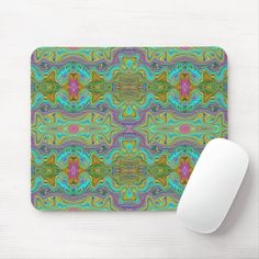 a computer mouse pad with an abstract design on the front and side, along with a white mouse