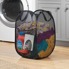 two laundry bags sitting in front of a washing machine