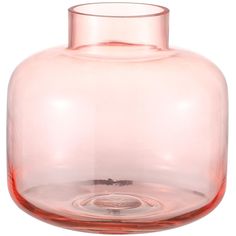 a clear glass vase sitting on top of a white table next to a red liquid