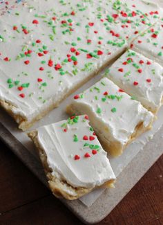 cake with white frosting and sprinkles cut into squares