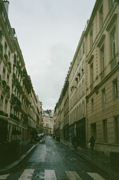 an empty city street with buildings on both sides