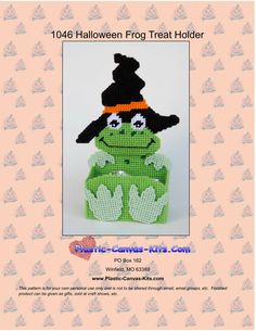 a green stuffed animal wearing a witches hat and holding a pumpkin on it's head