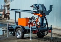 an orange and black machine on the back of a truck