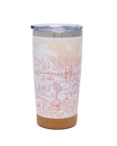 a white and orange tumbler cup with a desert scene on it