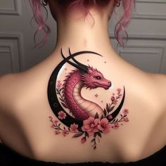 a woman's back with a dragon tattoo on her neck and flowers around the neck