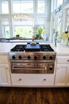 a stove top oven sitting inside of a kitchen