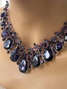 Radiant and luminous, this absolutely stunning bridal necklace! Beautifully designed V-shaped wedding necklace formed together by shining rhinestones with a glamorous drop pear cut stone! This also comes with matching teardrop earrings. Add an extra touch of romance for the bride, bridesmaids, or prom queen. • Color: Silver Stone Color: Purple Necklace Size: 18" to 21" adjustable Front Drop: 2" Earrings: 2" • Crystal Rhinestone Teardrop Bridal Wedding Necklace PLEASE NOTE: We offer a gift box wi Necklace Prom, Prom Jewelry Sets, Teardrop Jewelry, Prom Queen, Bridal Jewelry Set, Prom Queens, Prom Jewelry, Purple Necklace, Wedding Jewelry Sets