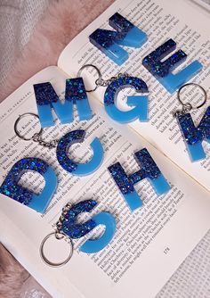 the letters are made out of plastic and have blue glitters on them as well as keychains