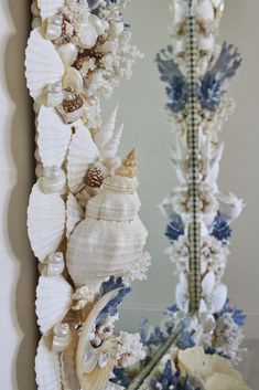 a mirror with seashells hanging on it