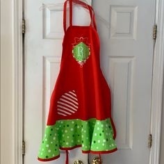 a red and green apron hanging on a door