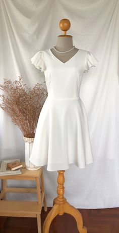 *DHL shipping upgrade is available at check out process. Shipping part by DHL will take 3-6 days only. Production time may take around 2-3 weeks. If this is in rush you can convo us to make it sooner.:) New in:) Alita dress in white. A sweet feminine look party dress which featured ruffle at sleeve, V shape neck bust line with flare swing skirt shape. This is lovely one for formal work teaming with a high heel or wear to a perfect summer day out to town. This is for all, grab one and you will in love with this dress.  Also custom length for this dress is available please convo. DESIGN✄: -Ruffle sleeve. -V neck. -Back zipper. -Swing skirt. -Fully Lining. -Longer length (requestable) please convo MATERIAL✄: *Amena fabric  (Polyester, bright color, solid shade, flattering one.) *Lining materi Cheap White Dresses For School, Affordable White Fitted Shirt Dress, Cheap White Knee-length Sleeveless Dress, Cheap White Dresses For Cheerleading, Cheap Fun White Dresses, Cheap White Sleeveless Party Dress, Cheap White Dresses With Pockets, Cheap Sweet White Dress, Cheap White Solid Color Dresses