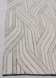 a white rug with wavy lines on it