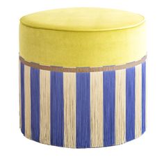 a yellow and blue stool with fringes on the bottom, sitting in front of a white background