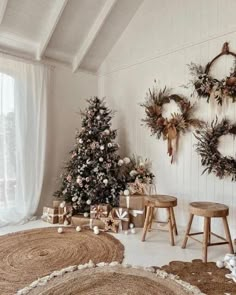 a living room decorated for christmas with wreaths on the wall