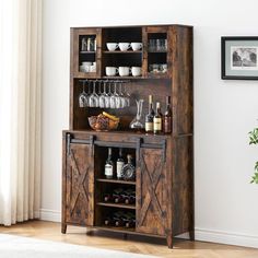 a wooden cabinet with wine glasses and bottles