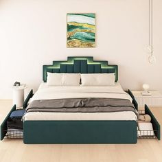 a large bed sitting on top of a hard wood floor next to a white wall