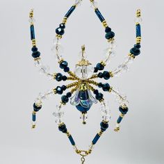 a blue and gold beaded chandelier hanging from a ceiling