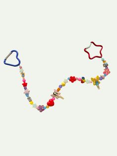 a beaded necklace with hearts, stars and other items hanging from it's sides