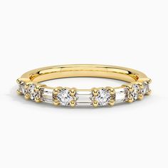 a gold and white diamond ring with three stones on the side, set in 18k yellow gold