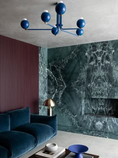 a living room with blue couches and marble walls