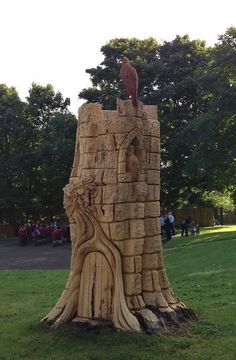 a large wooden sculpture in the middle of a park