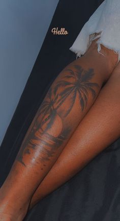 a woman's legs with palm trees on them