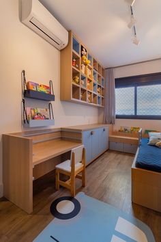 a room with a bed, desk and shelves