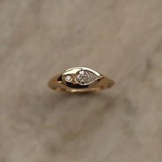 a gold ring with a diamond in the middle