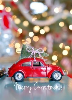 a red toy car with a christmas tree on top