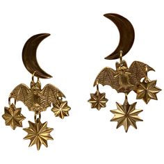 BATS!!!!!! These hand-hammered brass earrings features a Bat in flight against a celestial backdrop of the moon and stars. Perfect for the person who loves Bats, or Halloween, or both. Let it add a stylish and bold touch to your everyday look. Made here in Salem exclusively for us to go along with the Exhibition Bats! On view now through July 28, 2024. Brass with sterling silver posts. Nickel and lead free.2″ long. --- Made in Salem, Ma Jewelry Care General - Always remove jewelry and/or hair ac Bat Wing Earrings, Whimsigoth Accessories, Bat In Flight, Whimsigoth Jewelry, Celestial Backdrop, Moon Accessories, Moon Earring, Bat Jewelry, The Moon And Stars