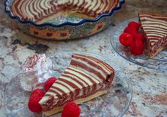 two slices of pie with raspberries and whipped cream