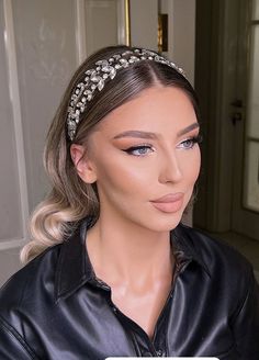 a woman wearing a black leather jacket and headband