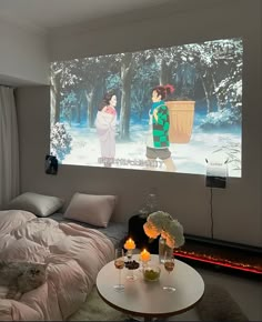 a bed room with a large screen on the wall