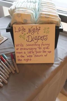 a sign that says late night diapers written on it next to some crayons