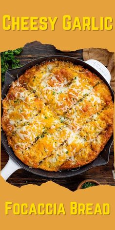 a cheesy garlic focaccia bread in a cast iron skillet