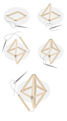 four pieces of wood are arranged in the shape of an origami kite with strings