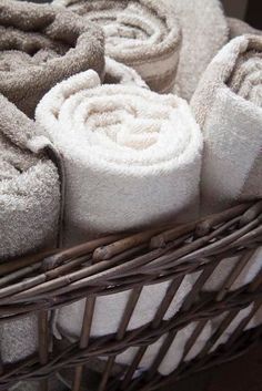 several folded towels in a wicker basket