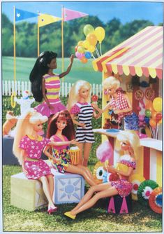 a group of barbie dolls sitting in front of a carnival booth