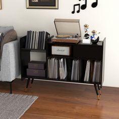 a living room with a couch, table and musical notes on the wall above it