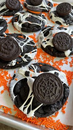 oreo cookies decorated with white icing and orange sprinkles