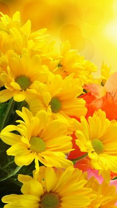 a bouquet of yellow and pink flowers on a table