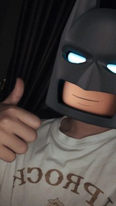 a man wearing a batman mask with glowing eyes