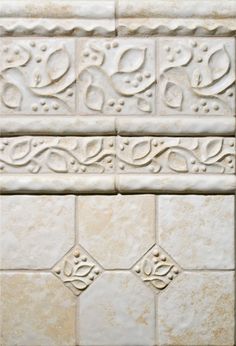 some white tiles with decorative designs on them